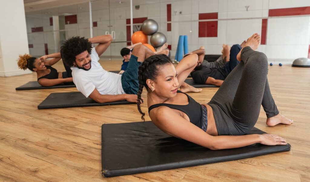 Foto de um grupo de pessoas fazendo exercícios de fortalecimento do core